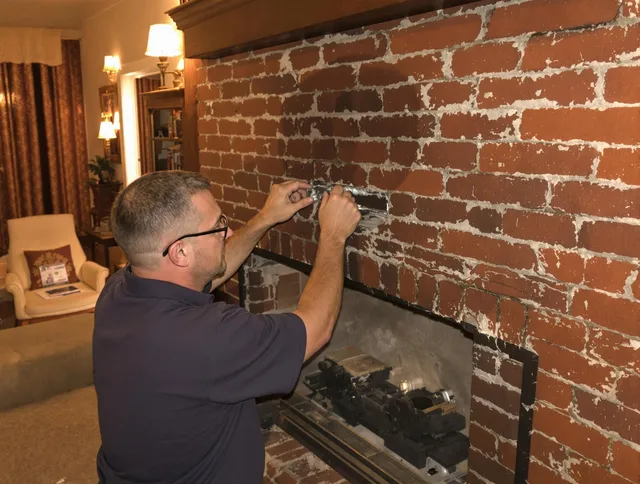 Norwich Chimney Sweep expert fixing a fireplace in Norwich, CT